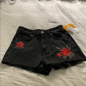 Black cut off jean shorts with floral design